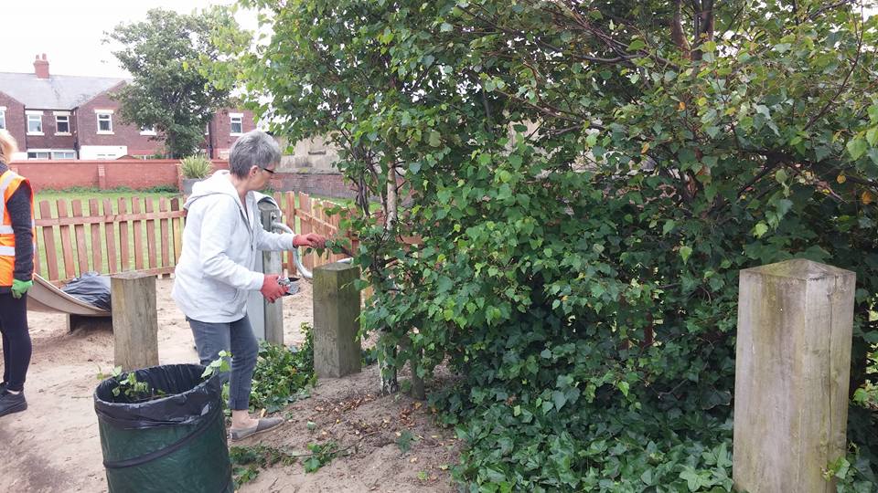 Irene Donavon gardening in the sand area