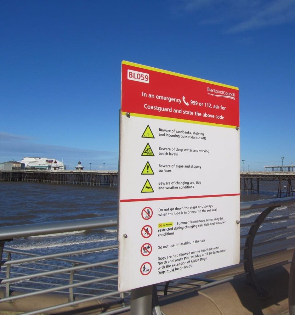 Beach safety and dog ban signs on Blackpool beach